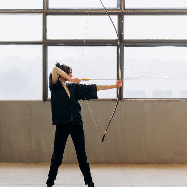 Person standing in a balanced pose, symbolizing strength and stability.